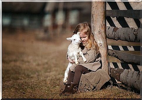 girl hugging lamb