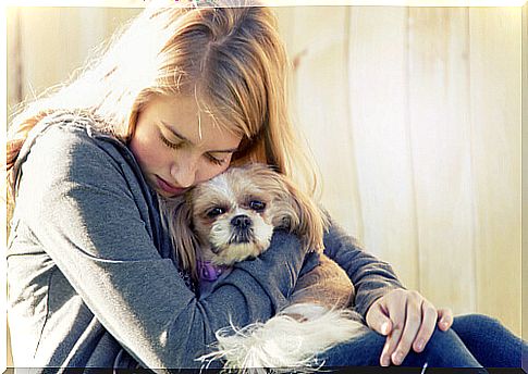 woman hugging her dog